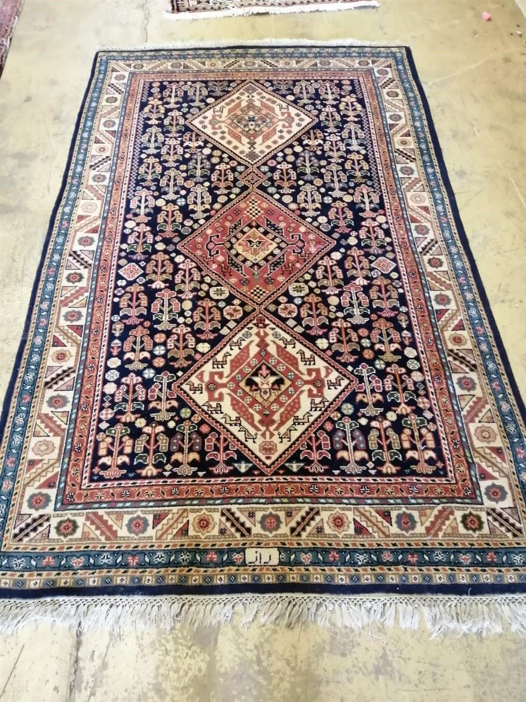 A Caucasian brick red ground carpet, 250 x 156cm